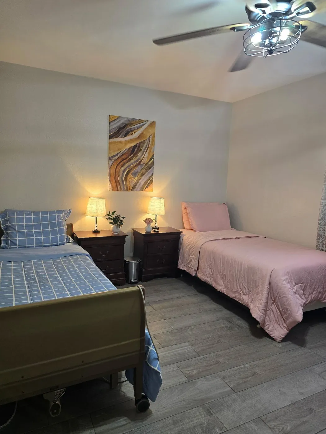 Two twin beds in a shared room at Latham in the evening, with warm lamplight on the bedside tables